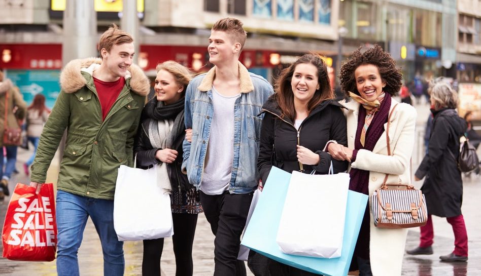 Group Of Young Friends Shopping Outdoors Together